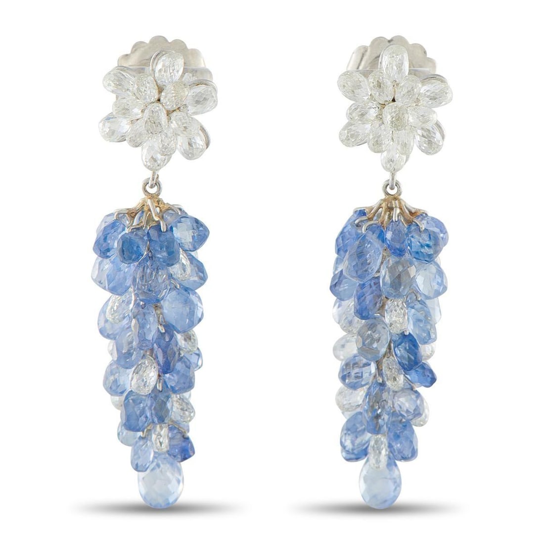 18K WHITE GOLD 5.0CT DIAMOND AND SAPPHIRE DANGLE EARRINGS: These uniquely elegant earrings are simply spectacular. At the base, Diamond briolettes with a total weight of 5.0 carats shine brightly every time they catch the light. Suspended below, a cascade of
