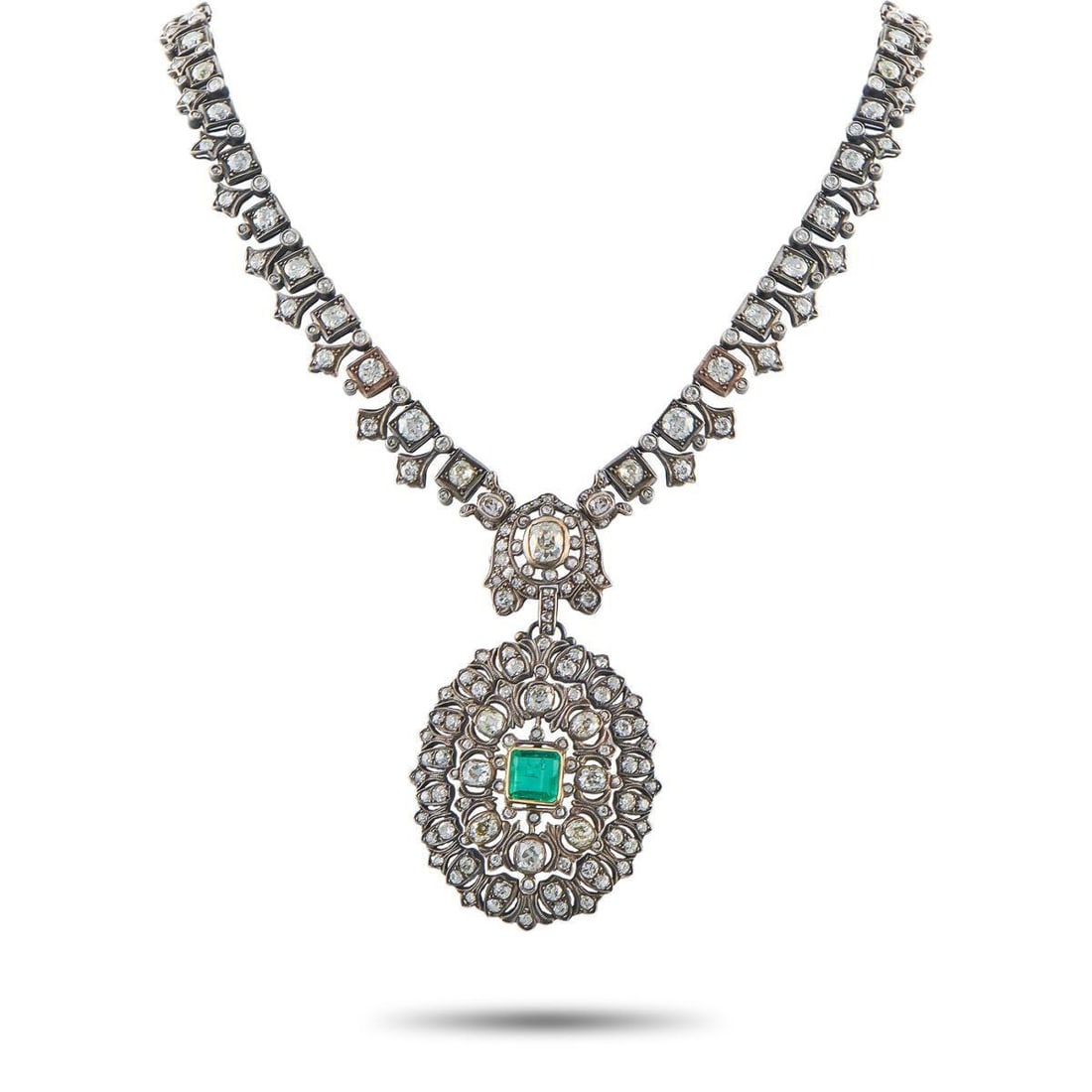 14K YELLOW GOLD AND SILVER 27.0CT DIAMOND AND EMERALD NECKLACE: An intricate openwork design makes this necklace instantly captivating. Crafted from a combination of 14K Yellow Gold and Silver, this luxury piece comes to life thanks to sparkling Diamonds with a to