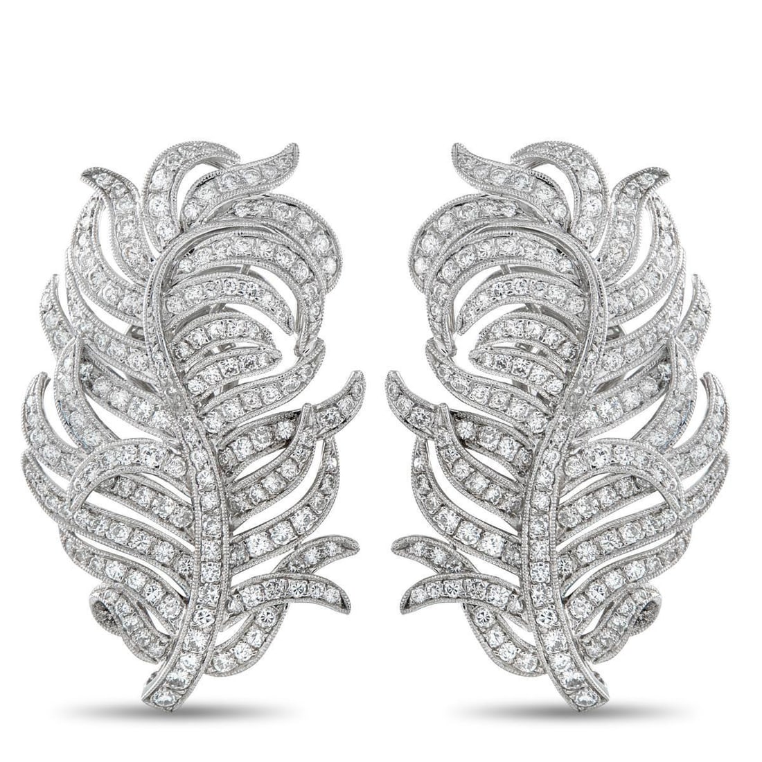 18K WHITE GOLD 3.50CT DIAMOND FEATHER EARRINGS: These white gold feather earrings draw on Jazz Age styling, when movement and ornament were celebrated through flowing form. Each earring follows the curve of a feather, its lines sweeping and taperin