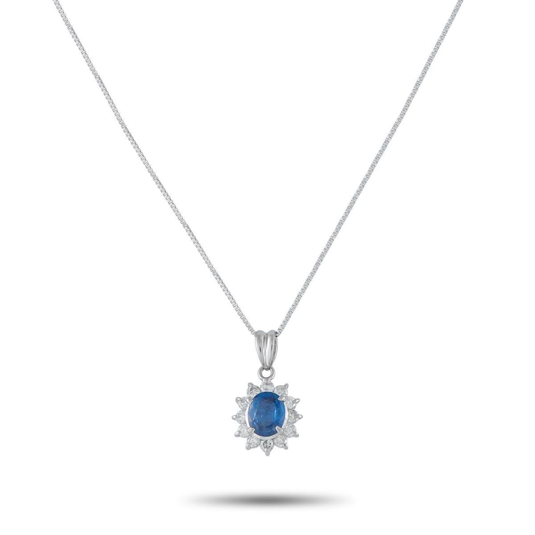 PLATINUM 0.44CT DIAMOND AND SAPPHIRE PENDANT NECKLACE: Add a touch of classic elegance to any ensemble with this timeless necklace. Set in Platinum, it features a 1.15 carat Sapphire center stone surrounded by Diamonds with a total weight of 0.44 carats.