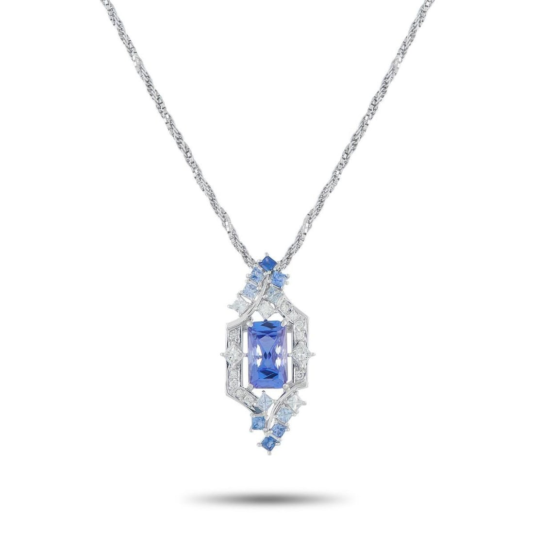 PLATINUM 0.48CT DIAMOND AND TANZANITE PENDANT NECKLACE: The design of this necklace is a tapestry of form and texture. It starts with a meticulously twisted chain, where the structured precision of box links seamlessly meets the supple flow of a cable chai