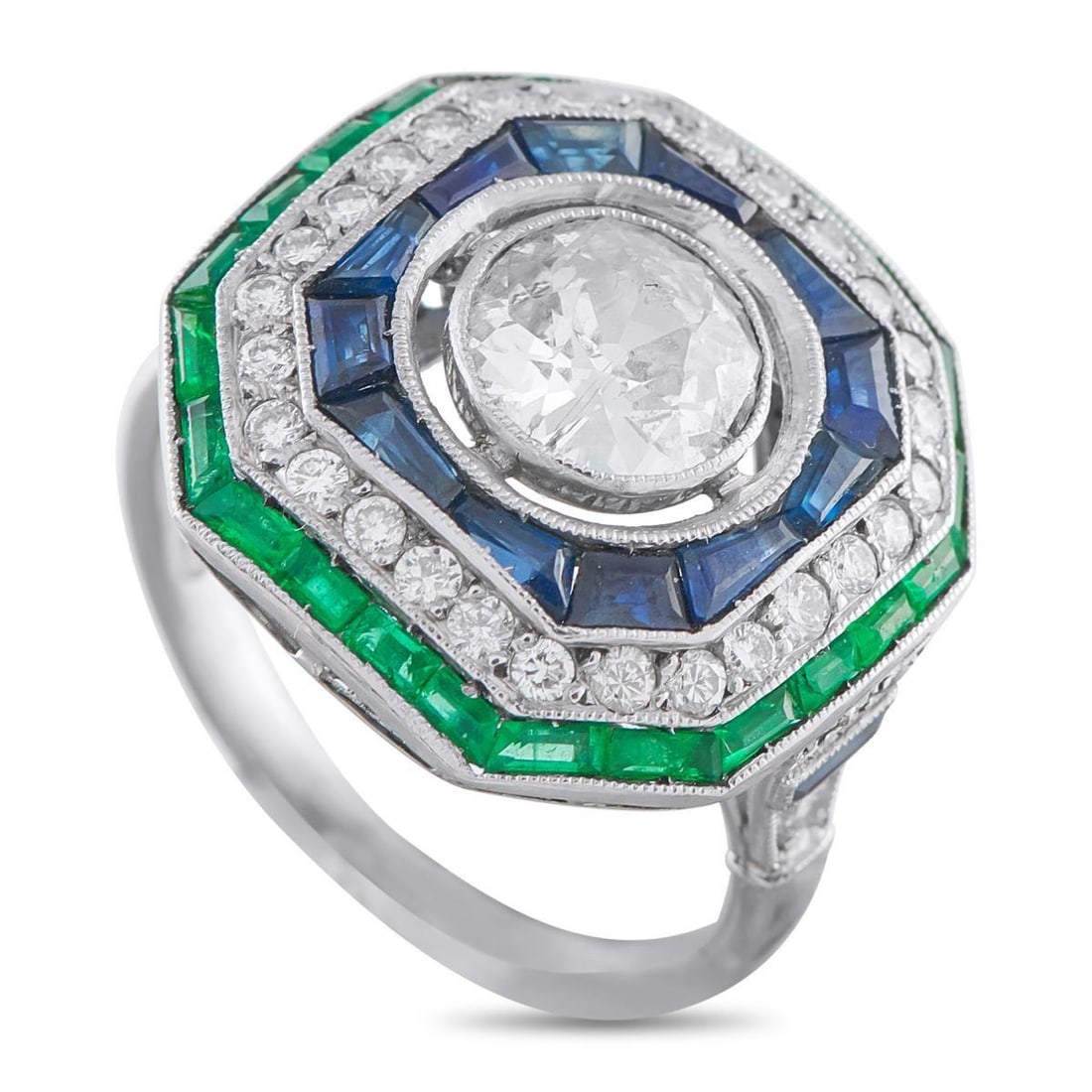 ANTIQUE PLATINUM 1.40CT DIAMOND, SAPPHIRE, AND EMERALD RING: Add vintage elegance to any ensemble with this radiant ring. The stunning geometric design is anchored by a dazzling 1.10 carat Diamond center stone. Sapphires, Emeralds, and Diamond accents totaling