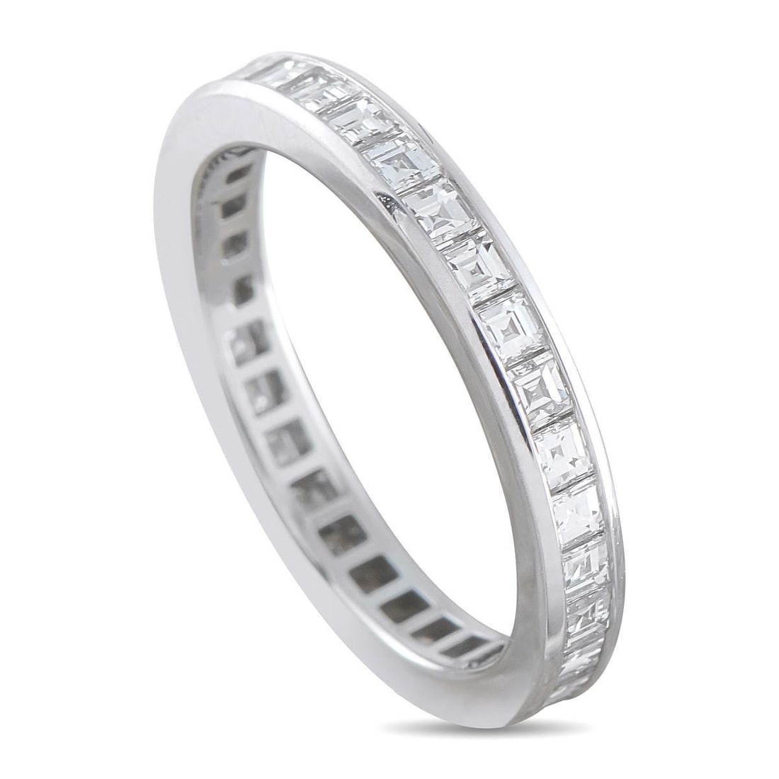 TIFFANY & CO. PLATINUM 1.02CT DIAMOND ETERNITY RING: This Tiffany & Co. eternity ring presents a full channel of square-cut diamonds encircling a slender 2mm platinum band, totaling 1.02 carats. The channel walls secure each stone edge to edge, forming