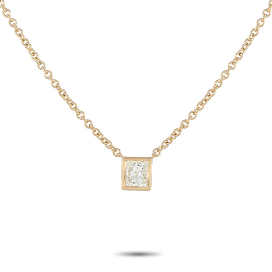 18K YELLOW GOLD 0.60CT PRINCESS-CUT DIAMOND SOLITAIRE NECKLACE: A simple and refined piece perfect for daily wear. A sharp, square princess-cut diamond takes center stage, its facets catching light with crisp, geometric brilliance. It is held securely by a smooth