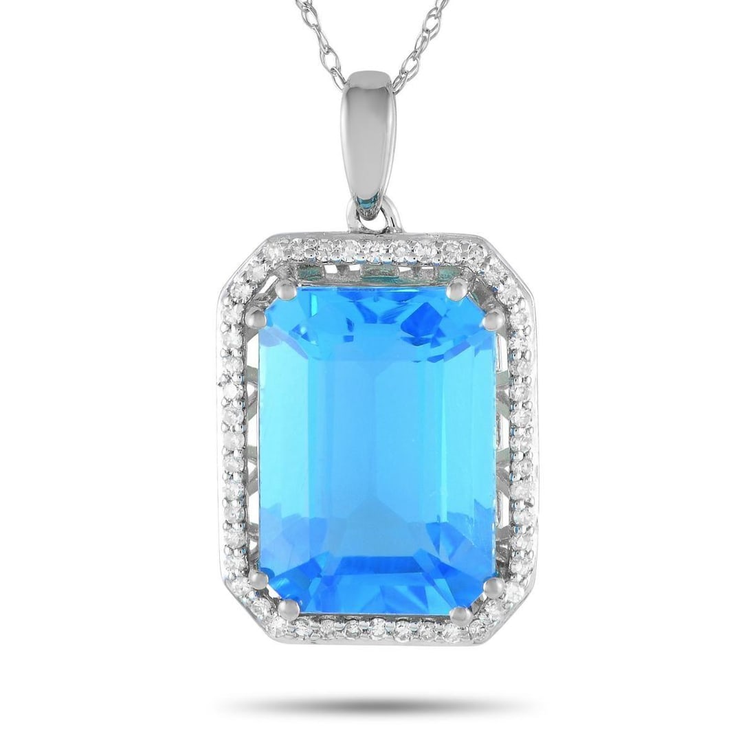 14K WHITE GOLD 0.20CT DIAMOND AND BLUE TOPAZ NECKLACE: Mark a special occasion with the exquisite beauty of this diamond and blue topaz necklace. The octagonal pendant measures 1 by 0.50 and has a frame of petite round diamonds. Sitting prominently at the