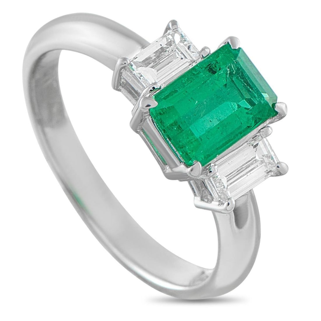 PLATINUM 0.51CT DIAMOND AND EMERALD THREE-STONE RING: This three-stone ring carries the profound symbolism of a relationship's past, present, and future. At its heart is a 1.15-carat emerald, its rich color flanked by two emerald-cut diamond side stones.