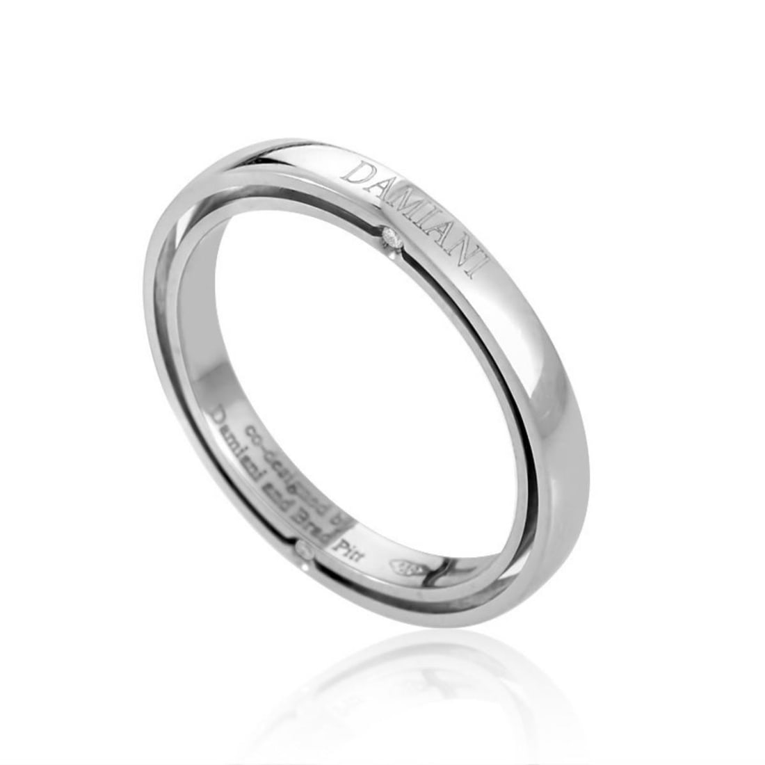 DAMIANI D.SIDE BRAD PITT PLATINUM 4-DIAMOND BAND RING: This simplistic band ring from Damiani has a classically elegant design perfect for a man or woman. The ring is made of 18K white gold and is studded with ~.03ct of diamonds. Category: Ring