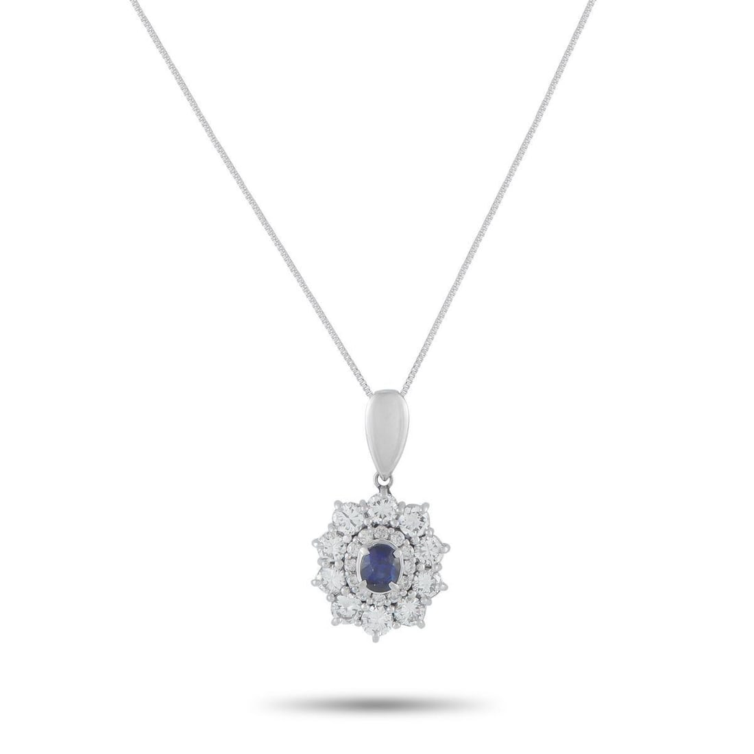 PLATINUM 1.25CT DIAMOND AND SAPPHIRE PENDANT NECKLACE: This luxury necklace is simply radiant. On this impressive piece, a 1.11 carat Sapphire center stone is surrounded by a double halo of Diamonds totaling 1.25 carats. Set in Platinum, the pendant measu