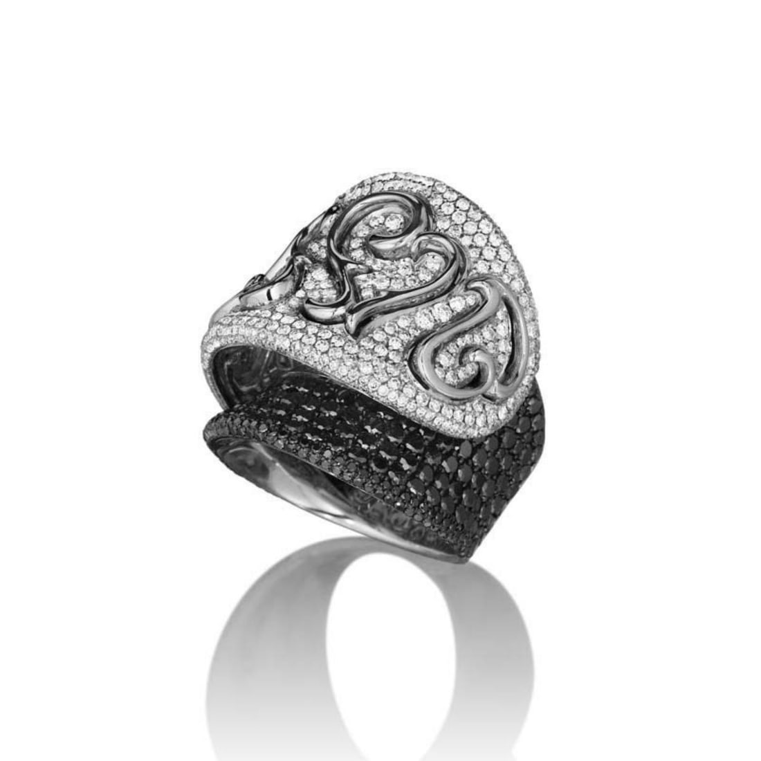 MAGGIORO 18K WHITE GOLD MULTI DIAMOND CURVED HEART RING: This ring from Maggioro's Rhapsody Collection is sensual and lovely. It is made of 18K white gold and boasts a design comprised of ~4.35ct of black and white diamonds. Category: Ring Condition: Brand