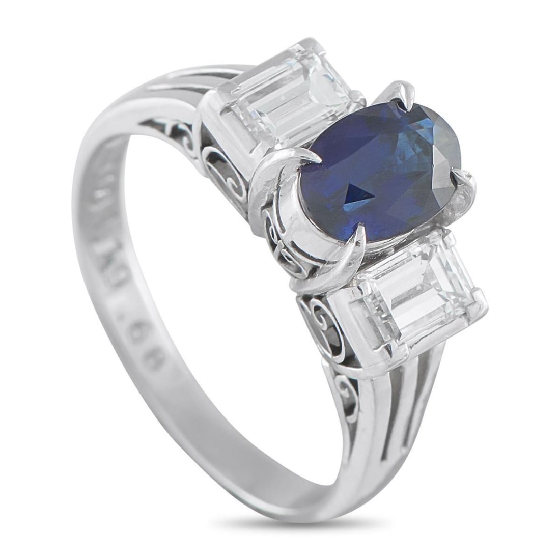 PLATINUM 0.68CT DIAMOND AND SAPPHIRE THREE-STONE RING: This ring's beauty lives in the contrast of color and brilliance, sharp form, and timeless appeal. It features a 1.19-carat oval sapphire framed by emerald-cut diamonds, rising on a platinum band with