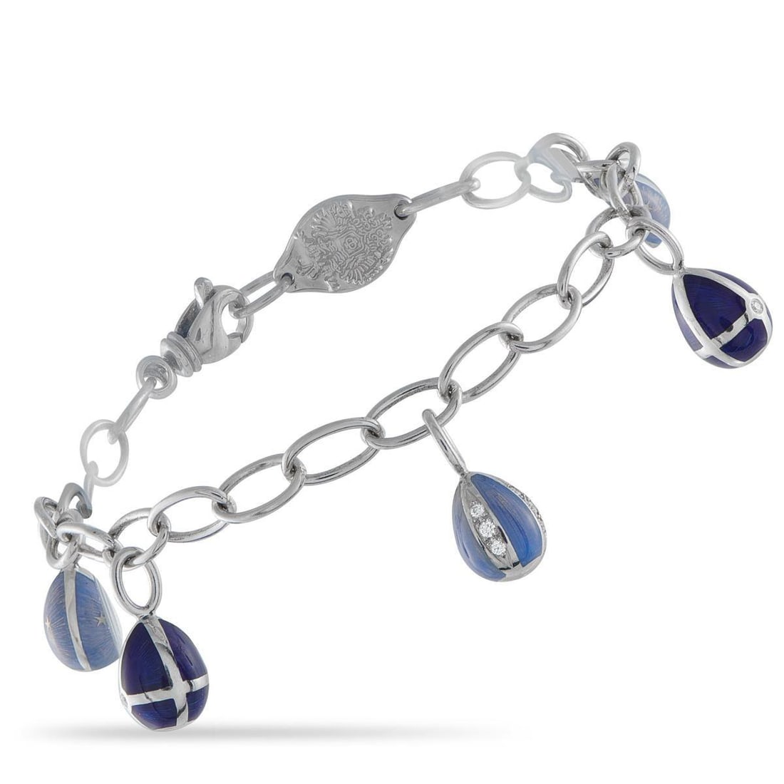 FABERGE 18K WHITE GOLD DIAMOND AND BLUE ENAMEL EGG CHARM BRACELET: This Faberg Egg Charm bracelet offers a playful reinterpretation of one of the luxury brands most iconic symbols. Suspended from this pieces 18K White Gold chain are series of miniature Faberg eggs el