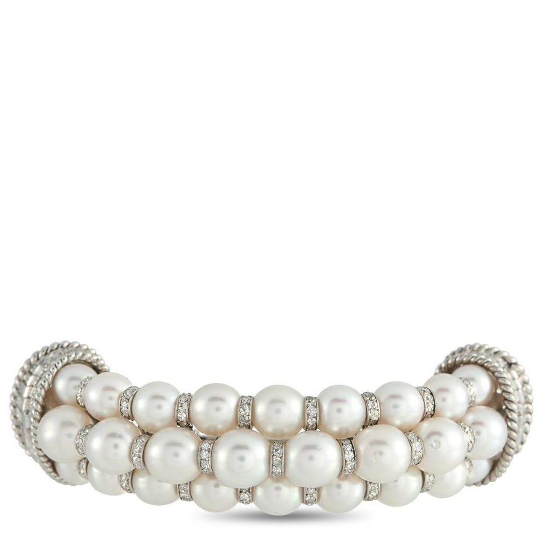 PLATINUM 3.80CT DIAMOND AND PEARL BROOCH: A curved Platinum setting adds dimension to this uniquely elegant brooch. Rows of Pearls provide this piece with a luminous quality, while Diamonds with a total weight of 3.80 carats add an
