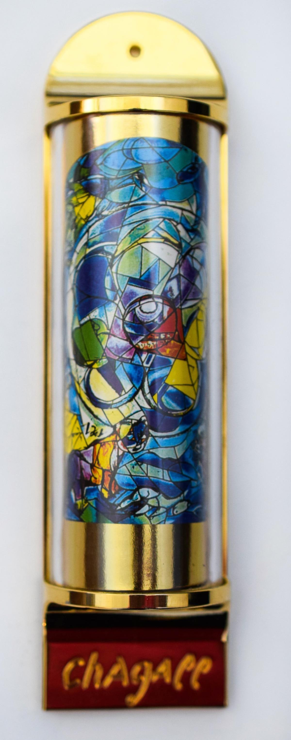 Marc Chagall- Mezuzah - silkscreen on 24K gold plated bronze "12 Tribes Hadassah Windows - Benjamin": Artist: Marc Chagall. Medium: Mezuzah - silkscreen on 24K gold plated bronze. Title: 12 Tribes Hadassah Windows - Benjamin. Size: 5" x 1.5". Reference#: 15694.