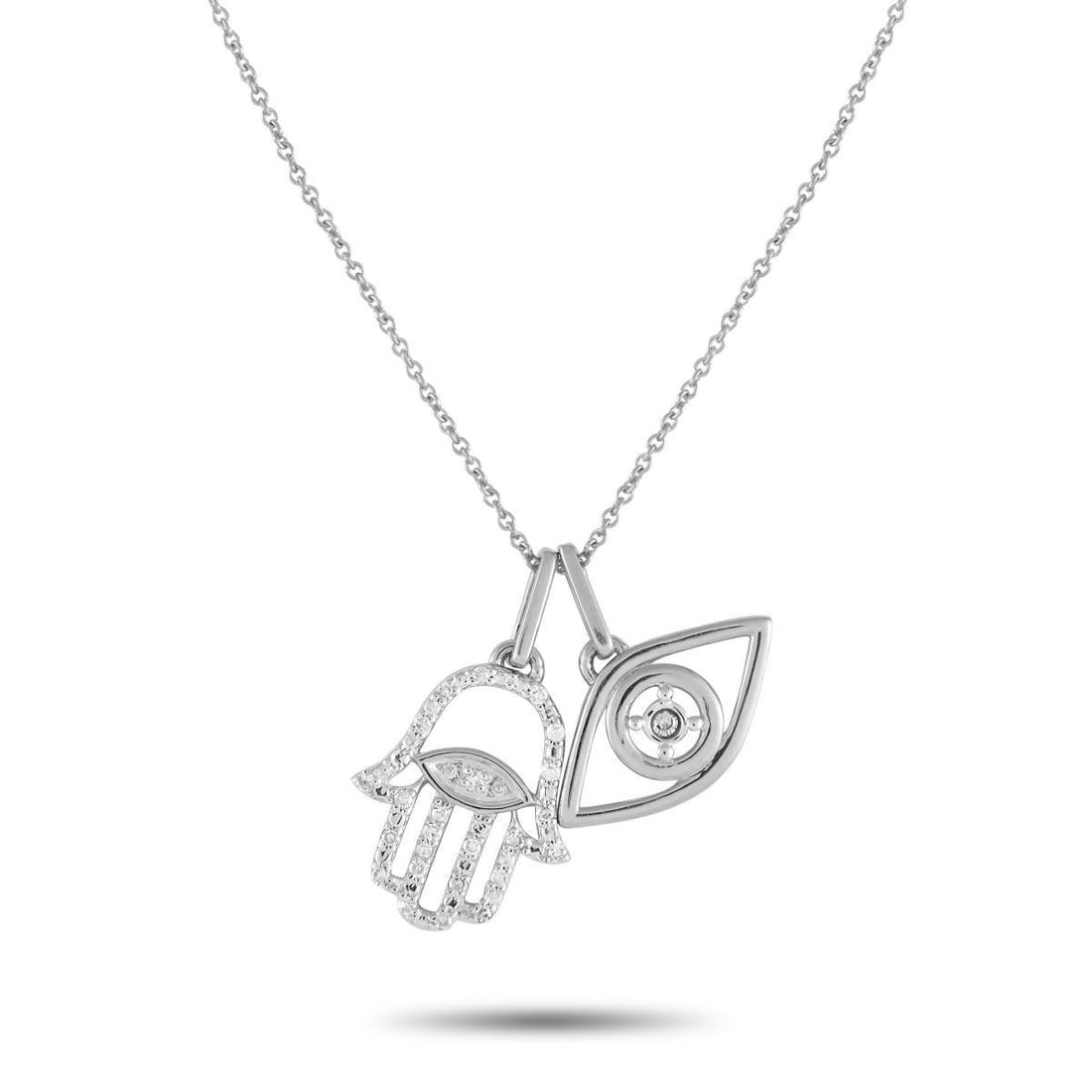 14K WHITE GOLD 0.10CT DIAMOND HAMSA PENDANT NECKLACE: On this exquisitely crafted necklace, a pair of spiritual symbols are suspended at the end of a delicate 18 chain. The Hamsa symbol has long been used as an amulet of good fortune, while the Evil Eye