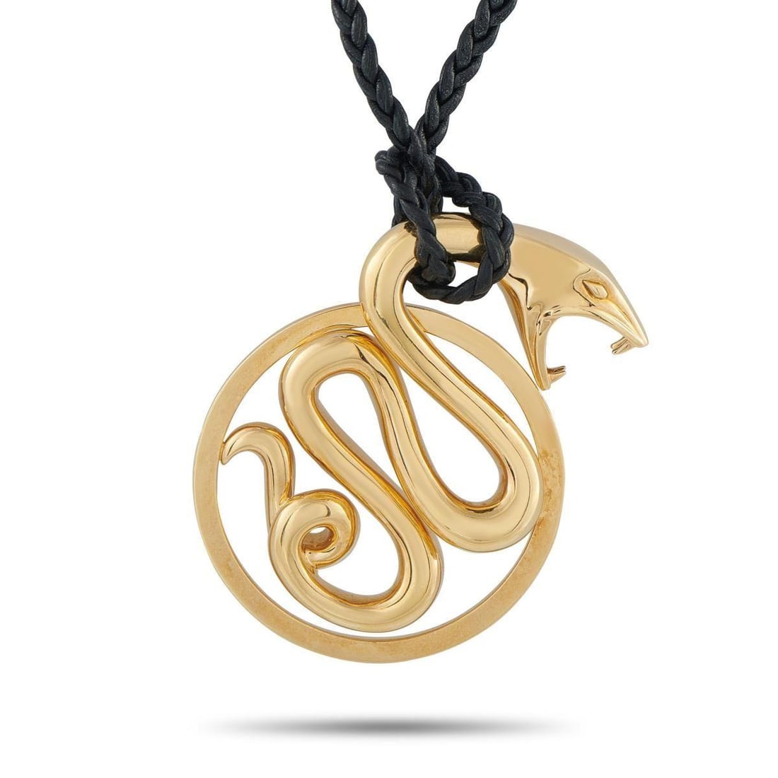 BOUCHERON 18K YELLOW GOLD SERPENT CORD NECKLACE: This Boucheron Serpent necklace is bold, confident, and will make a statement every time its worn. It features an 18K Yellow Gold circular snake pendant suspended from a 30 black cord. The pendant mea