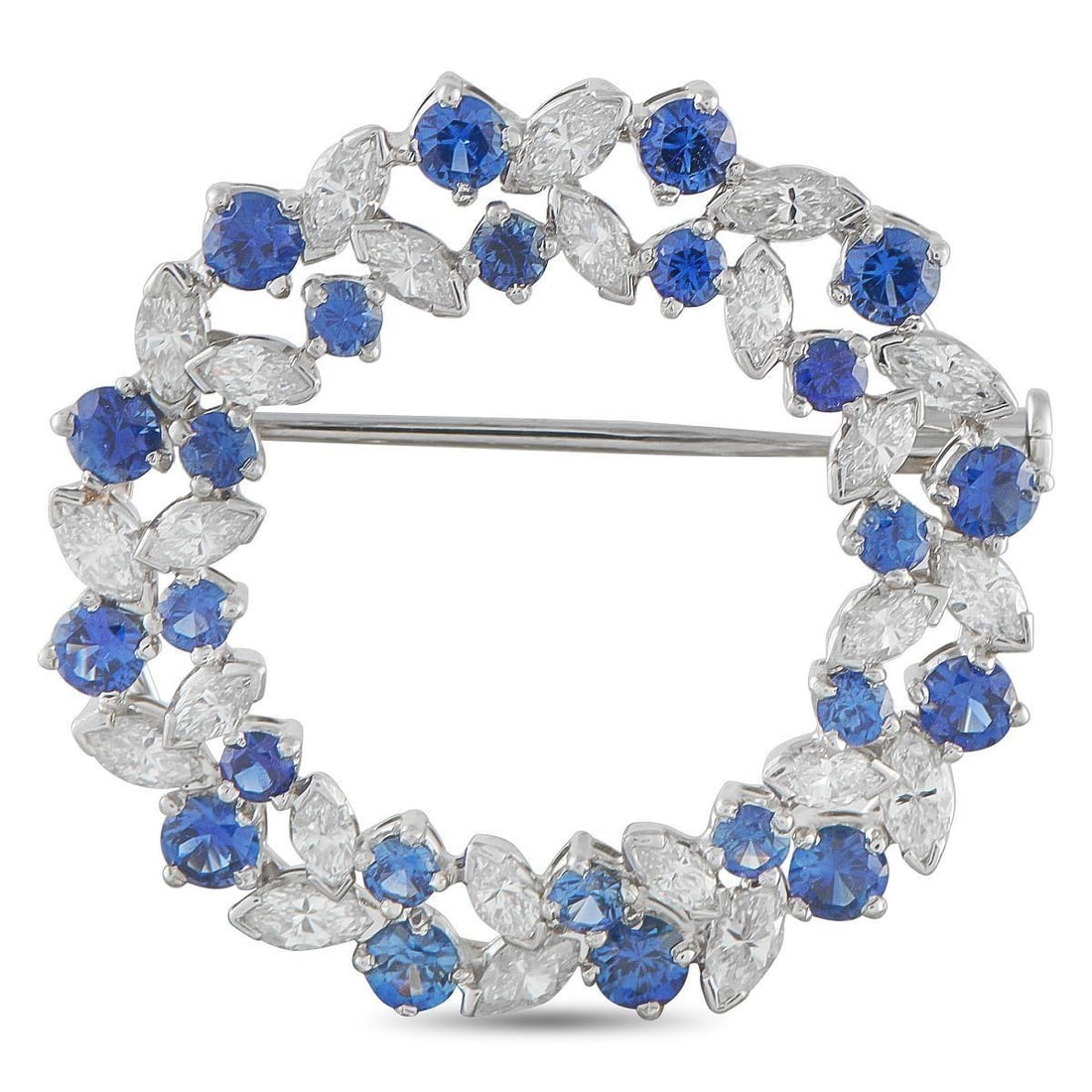 OSCAR HEYMAN PLATINUM 1.70CT DIAMOND AND SAPPHIRE CIRCLE BROOCH: Round. Regal. Radiant. This Oscar Heyman brooch is shaped like a refined wreath in platinum. Marquise diamonds sit with half bezels at each pointed end, alternating with round blue sapphires in varyin