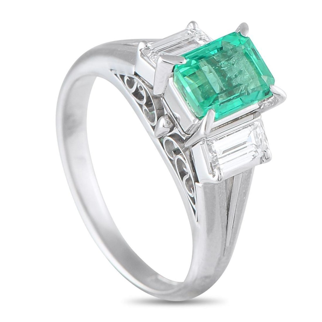 PLATINUM 0.51CT DIAMOND AND EMERALD RING: This luxury ring is filled with breathtaking details. A detailed Platinum setting beautifully showcases the classic three-stone design, which includes a 1.06 carat Emerald center stone and Diamond acc