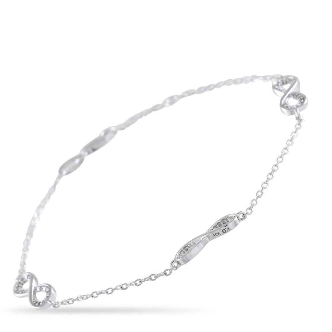 10K WHITE GOLD 0.17CT DIAMOND BRACELET: A series of sleek infinity symbols add elegance and visual impact to this delicate bracelet. Crafted from 10K White Gold, it measures 7.0 long and is elevated by sparkling Diamond accents totaling 0.1
