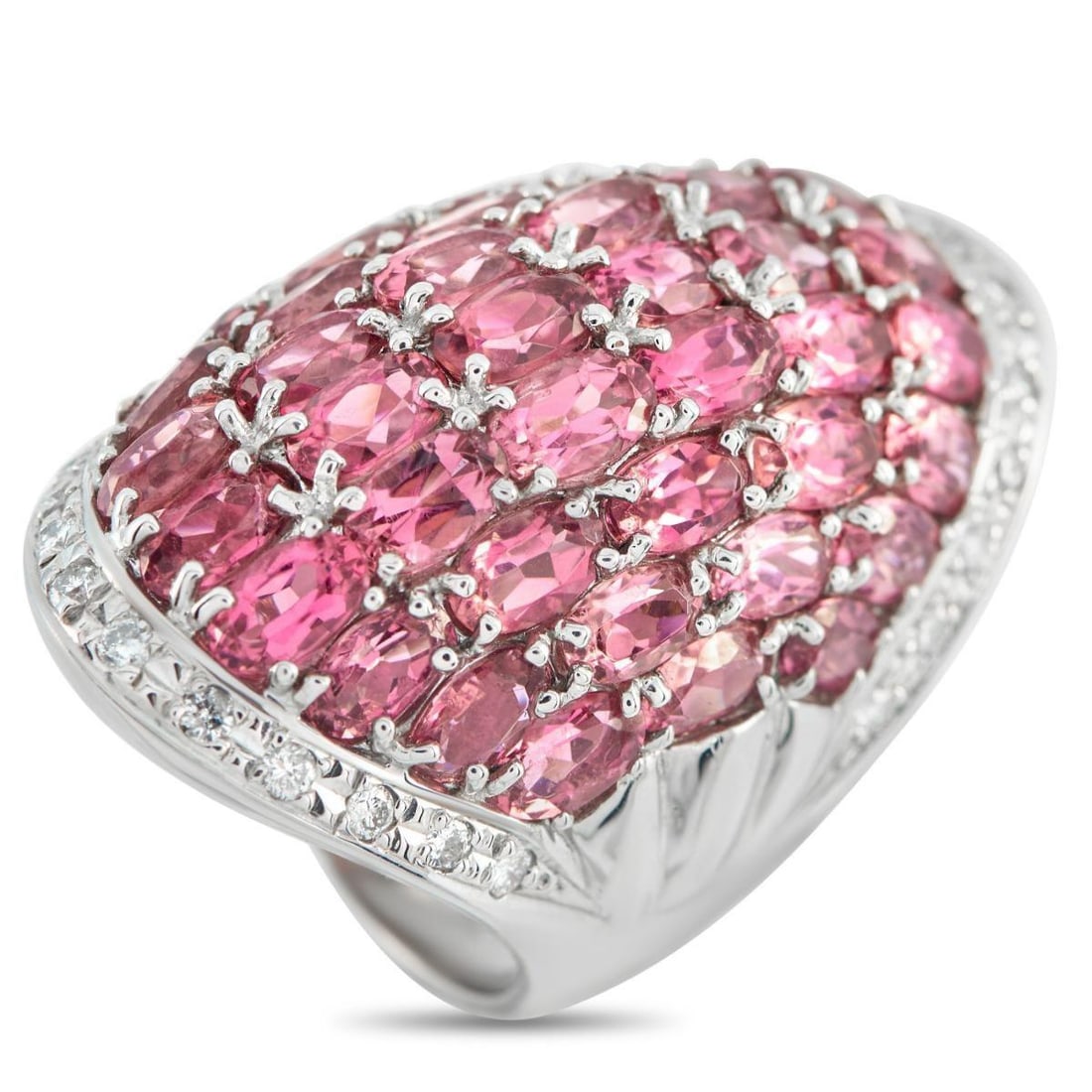 PLATINUM 0.48CT DIAMOND AND TOURMALINE COCKTAIL RING: Set with pink tourmalines, this showstopping cocktail ring makes a strong impression the moment it's worn. It showcases a broad, sculpted form, with a 35-by-20-millimeter top that curves gently, like