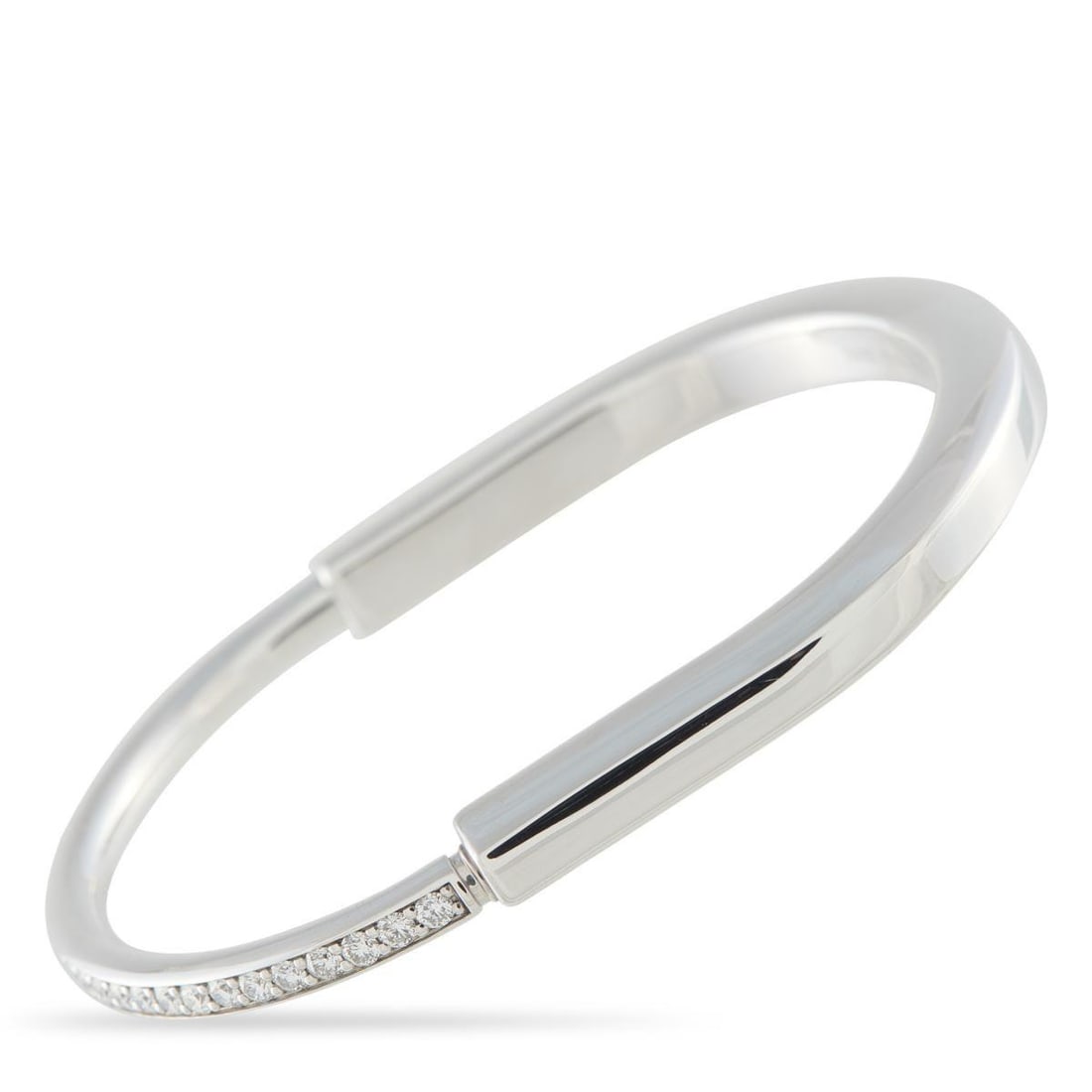 TIFFANY & CO. 18K WHITE GOLD 1.20CT DIAMOND LOCK BRACELET: Like all pieces from the collection, this Tiffany & Co. Lock bracelet creates beauty from the simplest forms. Designed to resemble a padlock, this chic bangle bracelet is elevated by sparkling Diamond
