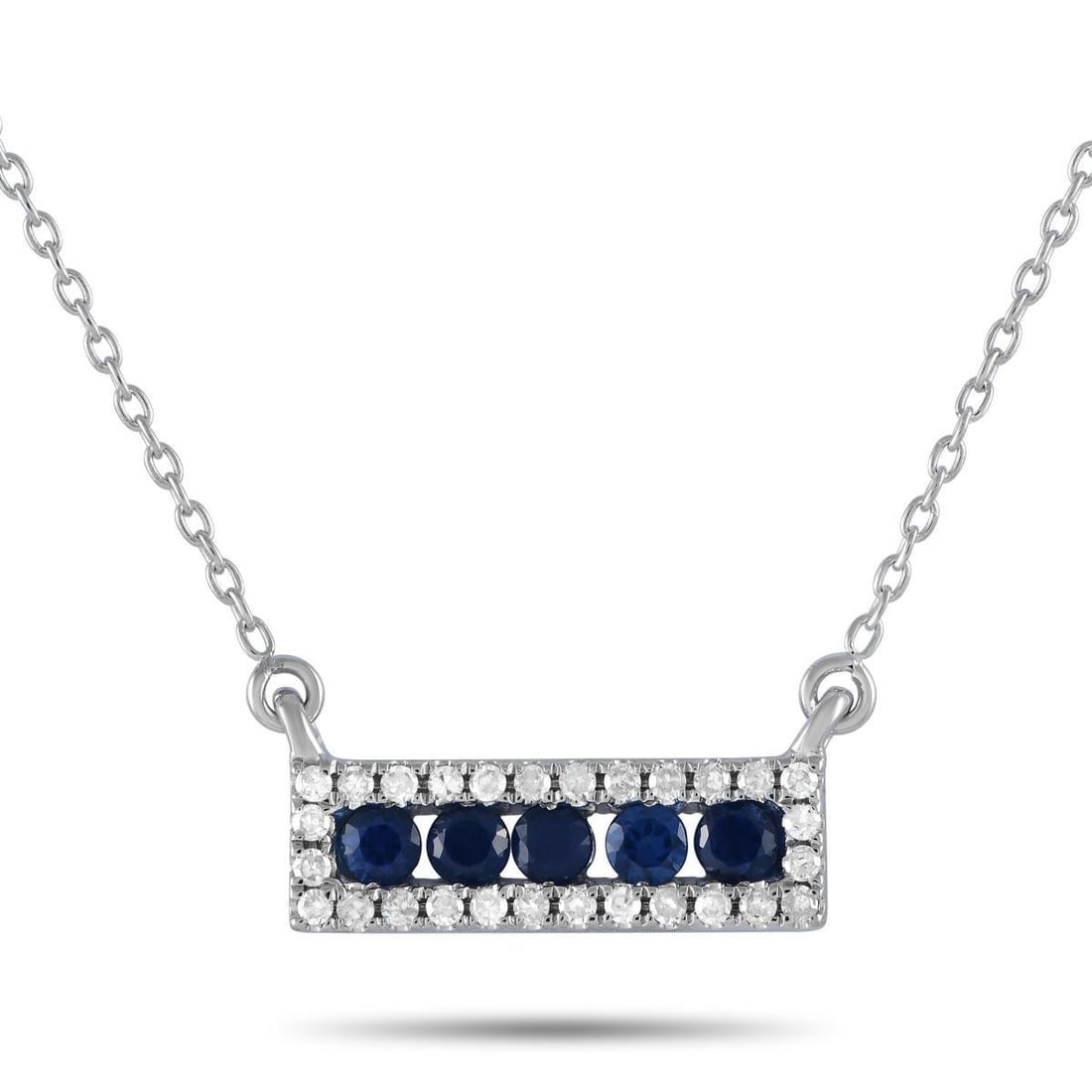 14K WHITE GOLD 0.15CT DIAMOND AND SAPPHIRE PENDANT NECKLACE: A series of Sapphires and Diamonds totaling 0.15 carats elevate this necklaces sophisticated 14K White Gold Pendant. Sleek and simple, its suspended at the center of an 18 chain and measures 0.15 long