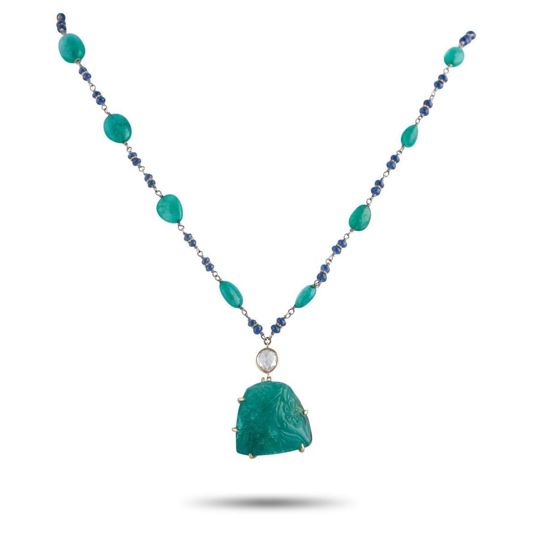 18K YELLOW GOLD 0.70CT DIAMOND AND EMERALD NECKLACE: This piece is an exploration of color and hand-worked detail. Along its 18K yellow gold chain are irregular emerald cabochons alternating with paired blue gemstone beads. Each emerald is slightly vari