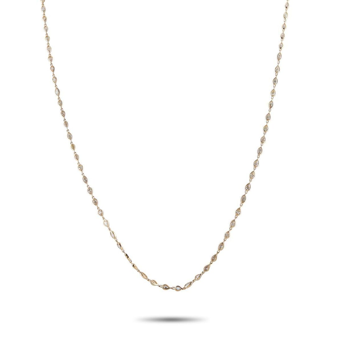 18K YELLOW GOLD 7.25CT DIAMOND TEARDROP LINE NECKLACE: A 32-inch chain in yellow gold, built from petite teardrop links with the occasional marquise shape for contrast. Each link is set with a diamond, sitting in an open-back setting that invites light to