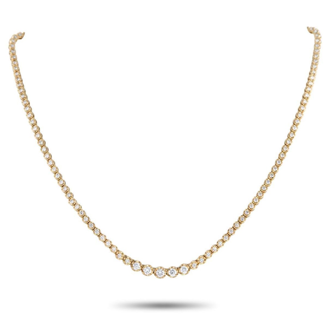 18K YELLOW GOLD 3.0CT DIAMOND LINE NECKLACE: Rather than following the standard tennis necklace layout, this 18K yellow gold diamond line necklace introduces a point of emphasis at its center. A short row of larger diamonds forms the focal