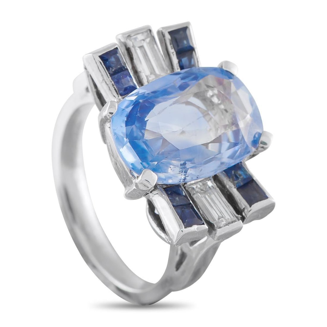 PLATINUM 0.40CT DIAMOND AND CEYLON SAPPHIRE COCKTAIL RING: Bright in daylight, vivid under evening light. This ring centers on a 7.51-carat oval Ceylon sapphire, unheated and secured by four prongs. Rectangular bezel accents flank the center: two set with duo
