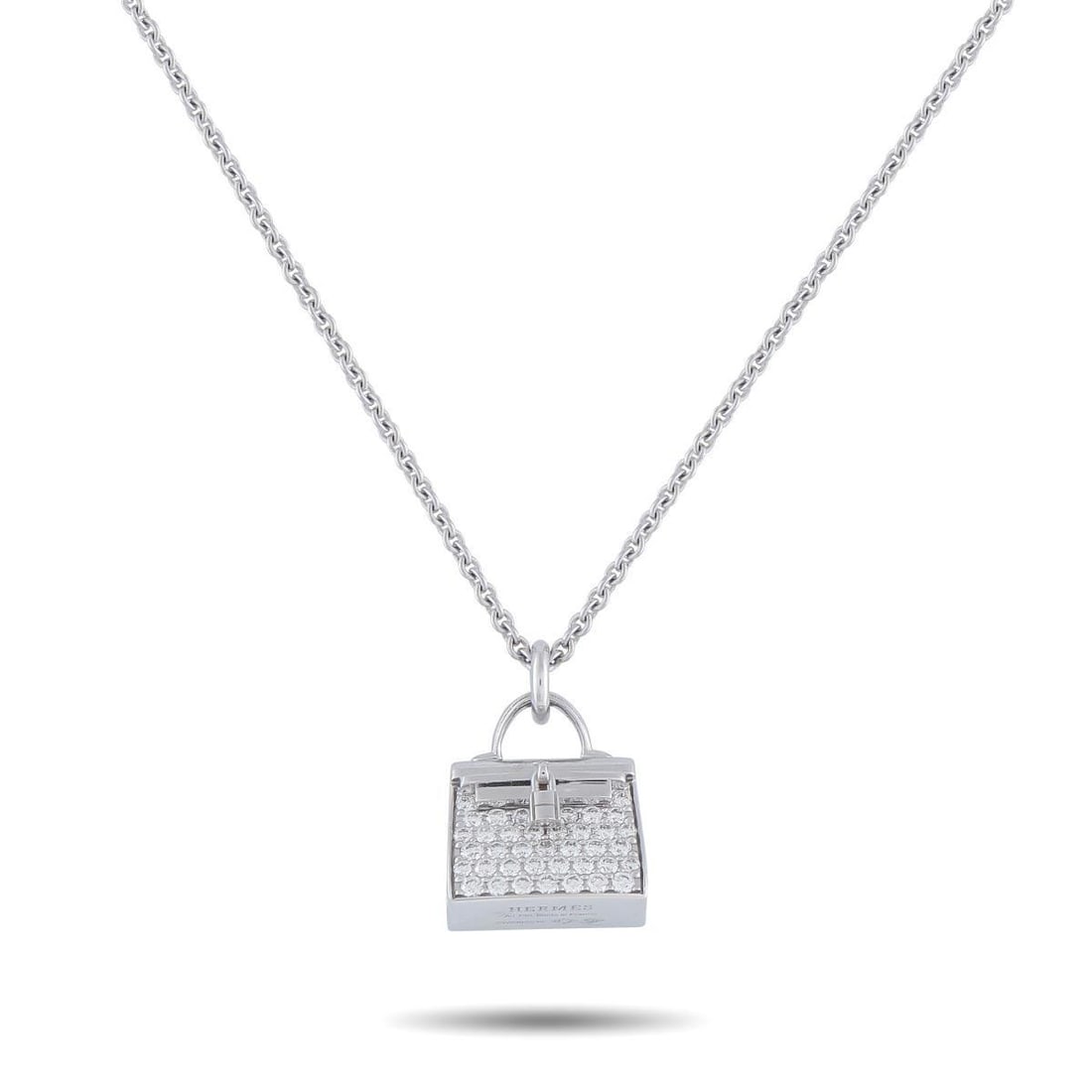 HERMES AMULETTES BIRKIN 18K WHITE GOLD DIAMOND PENDANT NECKLACE: This Hermes Amulettes Birkin necklace offers a stunning reinterpretation of one of the brands most iconic leather goods. On this piece, a perfectly proportioned Birkin pendant takes center stage. Spar