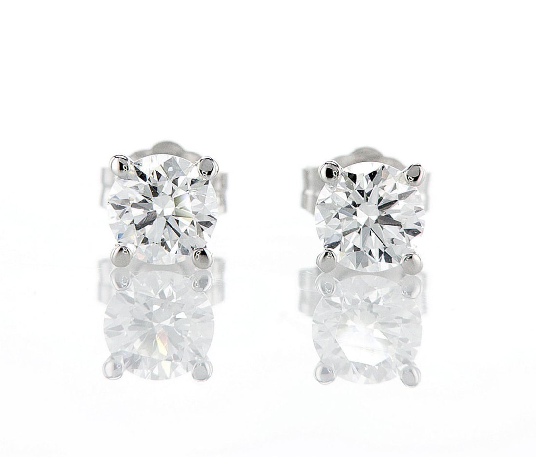 14kt White Gold 1.06ctw Diamond Earrings: One pair of 14k white gold earrings (14k stamped), each set with one lab grown diamond. Jewelry Weight: 1Grs Total Diamonds Weight: 1.06Cts Main Stones Description: Quantity: 2 Cut and shape: Round Br