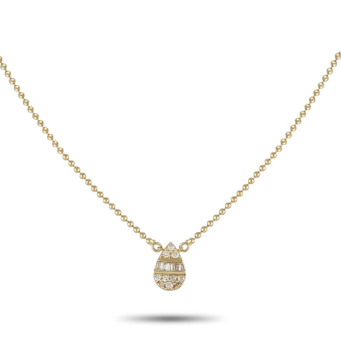 14K YELLOW GOLD 0.11CT DIAMOND PENDANT NECKLACE: Add a touch of sparkle to any ensemble by adding this subtle, sophisticated necklace. A pear-shaped pendant measuring 0.28 long by 0.25 wide is suspended at the center of a 16 ball chain. Diamonds wit