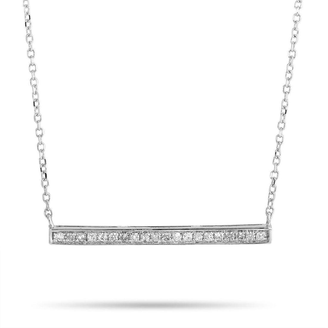 14K WHITE GOLD 0.10CT DIAMOND PENDANT NECKLACE: This necklace is crafted from 14K white gold and weighs 1.8 grams. It is presented with a 16 chain and a pendant that measures 0.15 in length and 1 in width. The necklace is embellished with diamonds 