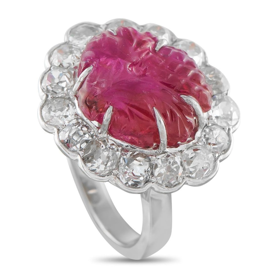 PLATINUM 3.0CT DIAMOND AND CARVED BURMA RUBY COCKTAIL RING: More than a cocktail ring by category, this piece appears almost inspired by the drink itself. At its center, an 11.0 ct Burmese ruby features a fruit pattern carving, held by six fine claw prongs. A 