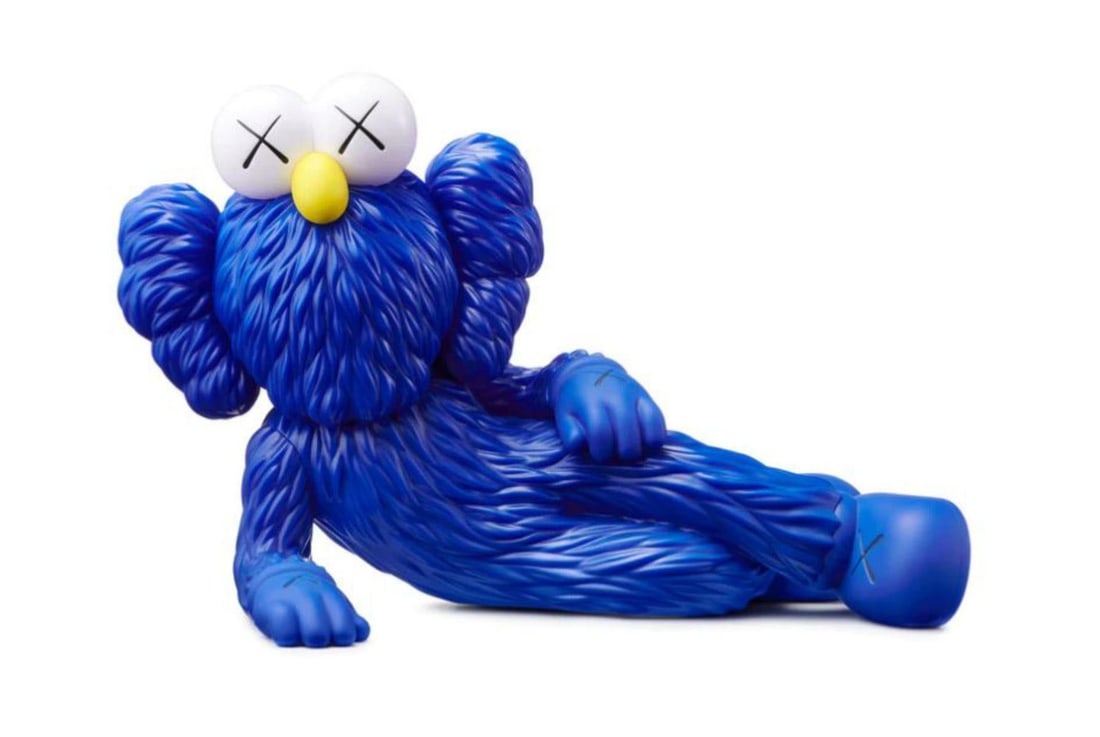 Kaws- Vinyl Figure "Time Off (Blue)": Artist: Kaws. Medium: Vinyl Figure. Title: Time Off (Blue). Size: 7" x 11". Certificate of Authenticity: Is included. Additional: The figure is new in box. Dimensions: 7" x 11" x 5.5". Reference#: 208
