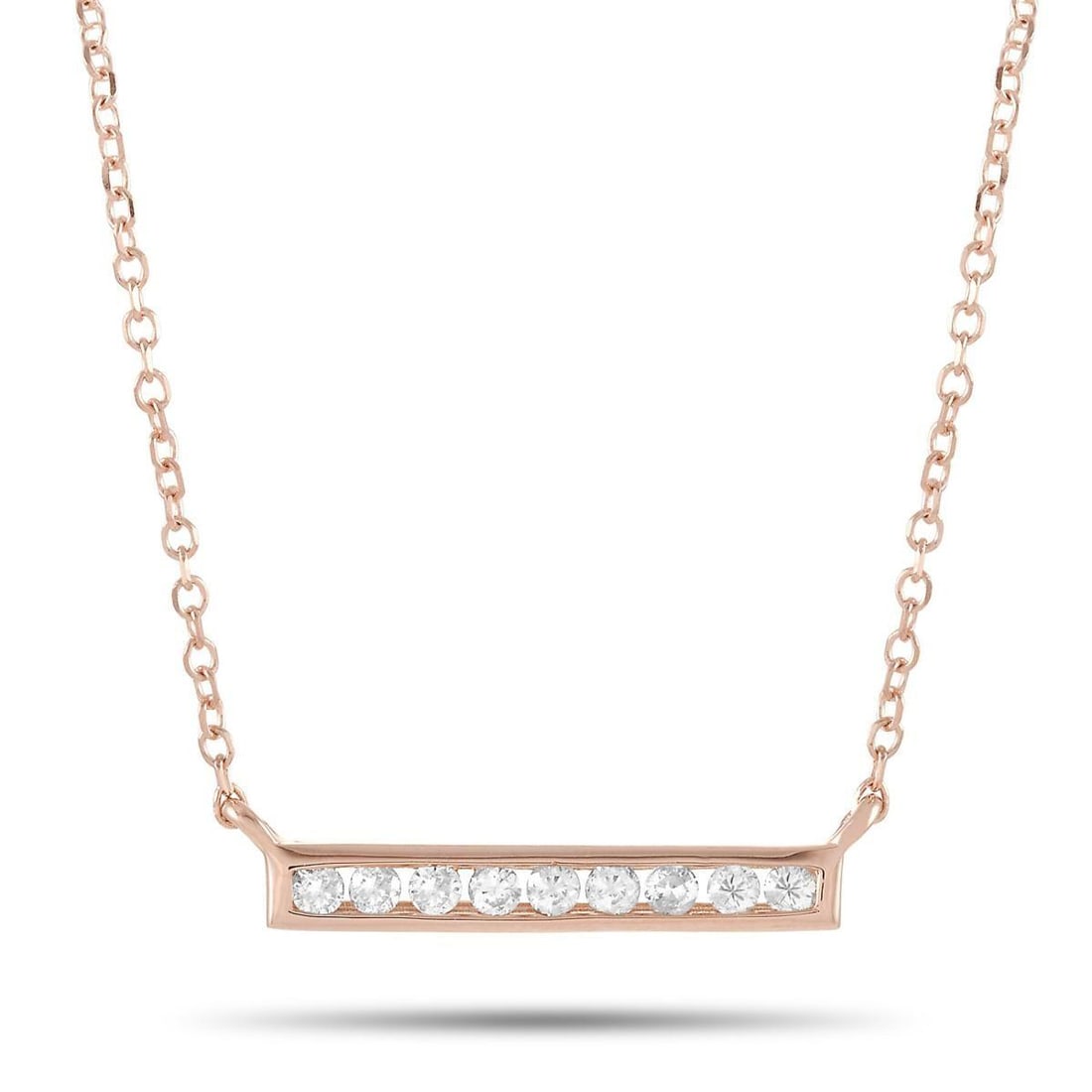 14K ROSE GOLD 0.10 CT DIAMOND PENDANT NECKLACE: This necklace is crafted from 14K rose gold and weighs 1.6 grams. It is presented with a 15 chain and boasts a pendant that measures 0.13 in length and 0.50 in width. The necklace is set with diamonds