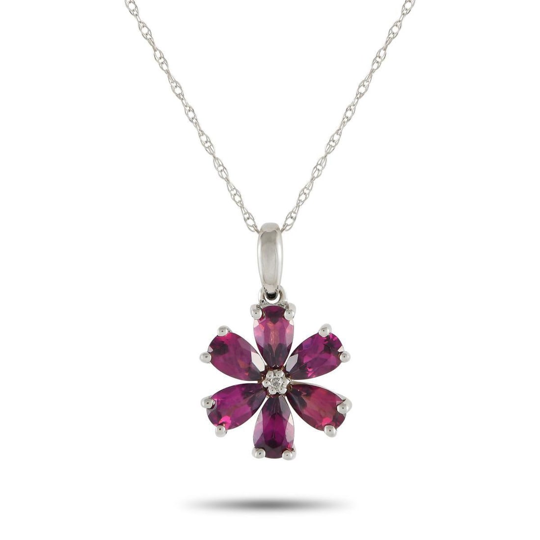 14K WHITE GOLD 0.01CT DIAMOND AND RHODOLITE FLOWER NECKLACE: Captivating rhodolite petals make this luxury necklace instantly captivating. Simple and elegant in design, the floral shaped pendant measures 0.75 long by 0.50 wide and is suspended from an 18 chain.
