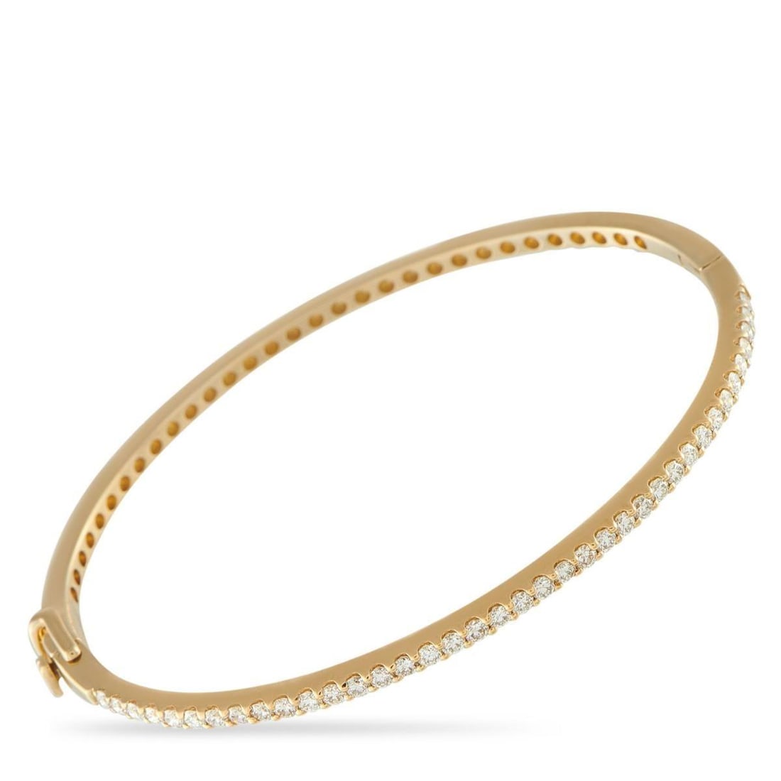 14K YELLOW GOLD 1.12CT DIAMOND BANGLE BRACELET: This 14K yellow gold bangle encircles the wrist in a polished, gleaming line. The bangle is accented with 1.12 carats of diamonds that catch light with every move. The hinged design keeps the silhouet