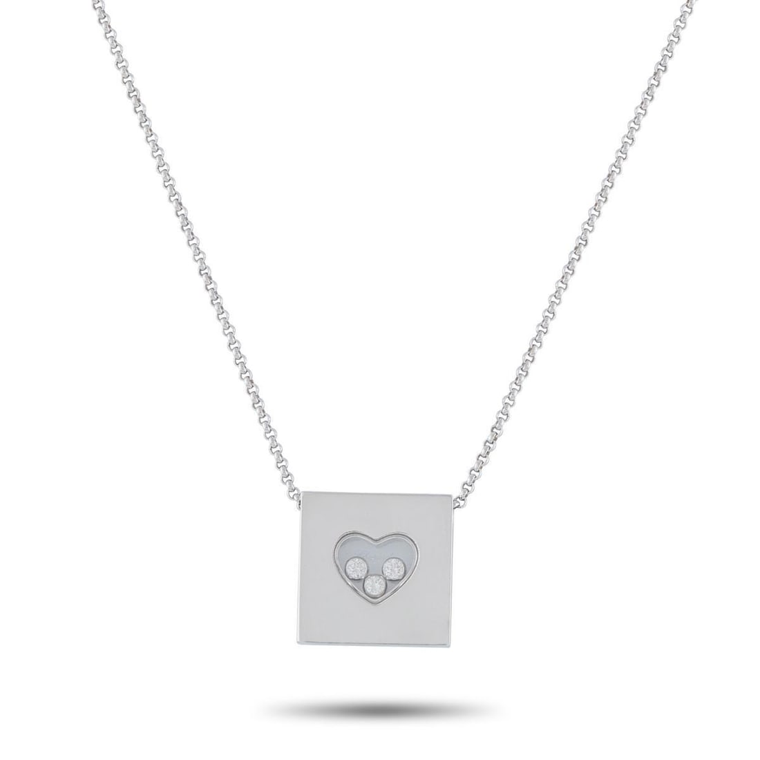 CHOPARD HAPPY DIAMONDS 18K WHITE GOLD 0.17CT DIAMOND NECKLACE: This Chopard Happy Diamonds necklace offers enduring elegance. The pendant includes a transparent heart-shaped center that contains a trio of floating Diamonds totaling 0.17 carats. Crafted from 18K W