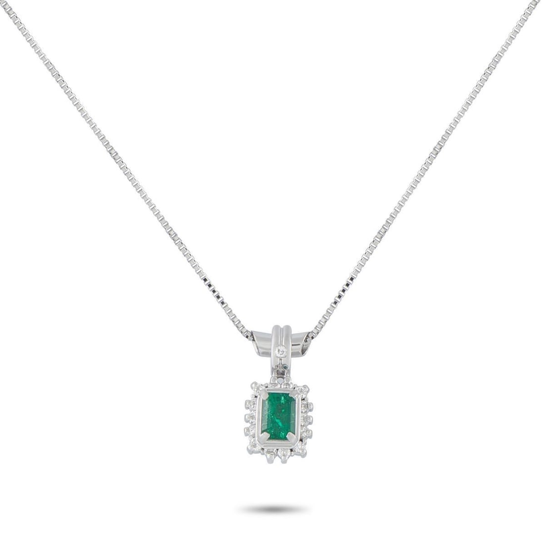 PLATINUM 0.12CT DIAMOND AND EMERALD PENDANT NECKLACE: This luxury pendant necklace offers a stunning sense of simplicity. A 0.41 carat Emerald adds a stylish splash of color, while Diamond accents totaling 0.12 carats further elevate the design. Set in P