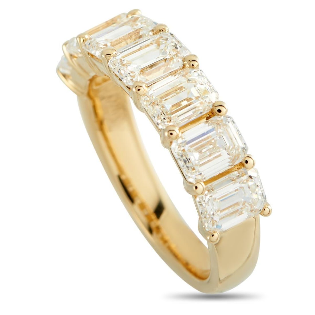18K YELLOW GOLD 3.60CT DIAMOND RING: A series of emerald cut Diamonds totaling 3.60 carats make a statement at the top of this simple, elegant ring. Ideal for everyday wear, the 18K Yellow Gold setting features a 3mm wide band and a 3mm 