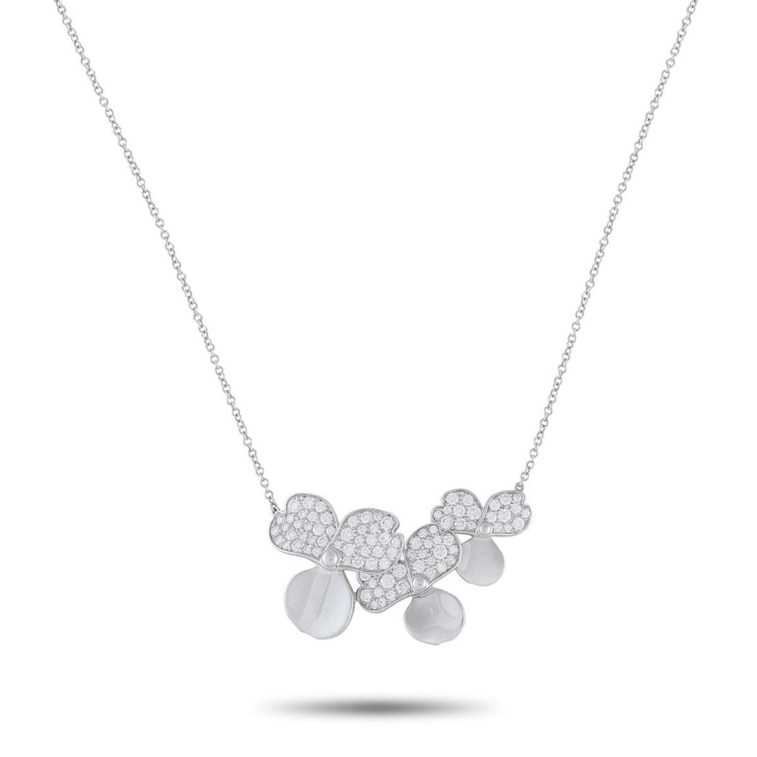 TIFFANY & CO. PAPER FLOWERS PLATINUM DIAMOND PENDANT NECKLACE: This Tiffany & Co. Paper Flowers necklace balances a soft, feminine aesthetic with sleek sophistication. Set in Platinum, the three-petal floral motifs are elevated by dazzling inset Diamonds. The pen