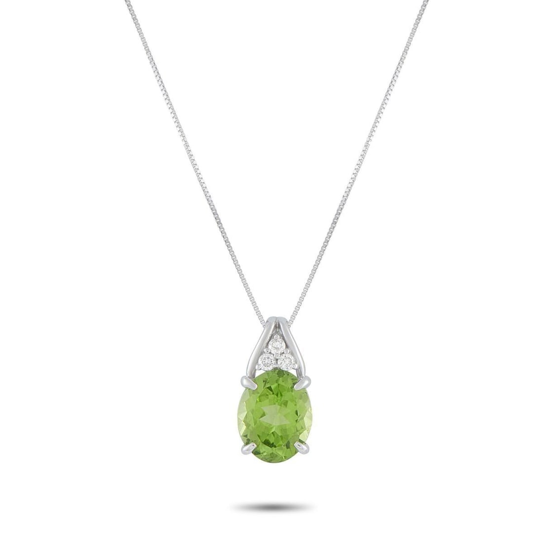 PLATINUM 0.09CT DIAMOND AND PERIDOT PENDANT NECKLACE: An understated design makes this necklace an effortless addition to any jewelry collection. Set in 18K White Gold, a 3.65 carat Peridot gemstone is accented by Diamonds totaling 0.09 carats. The penda