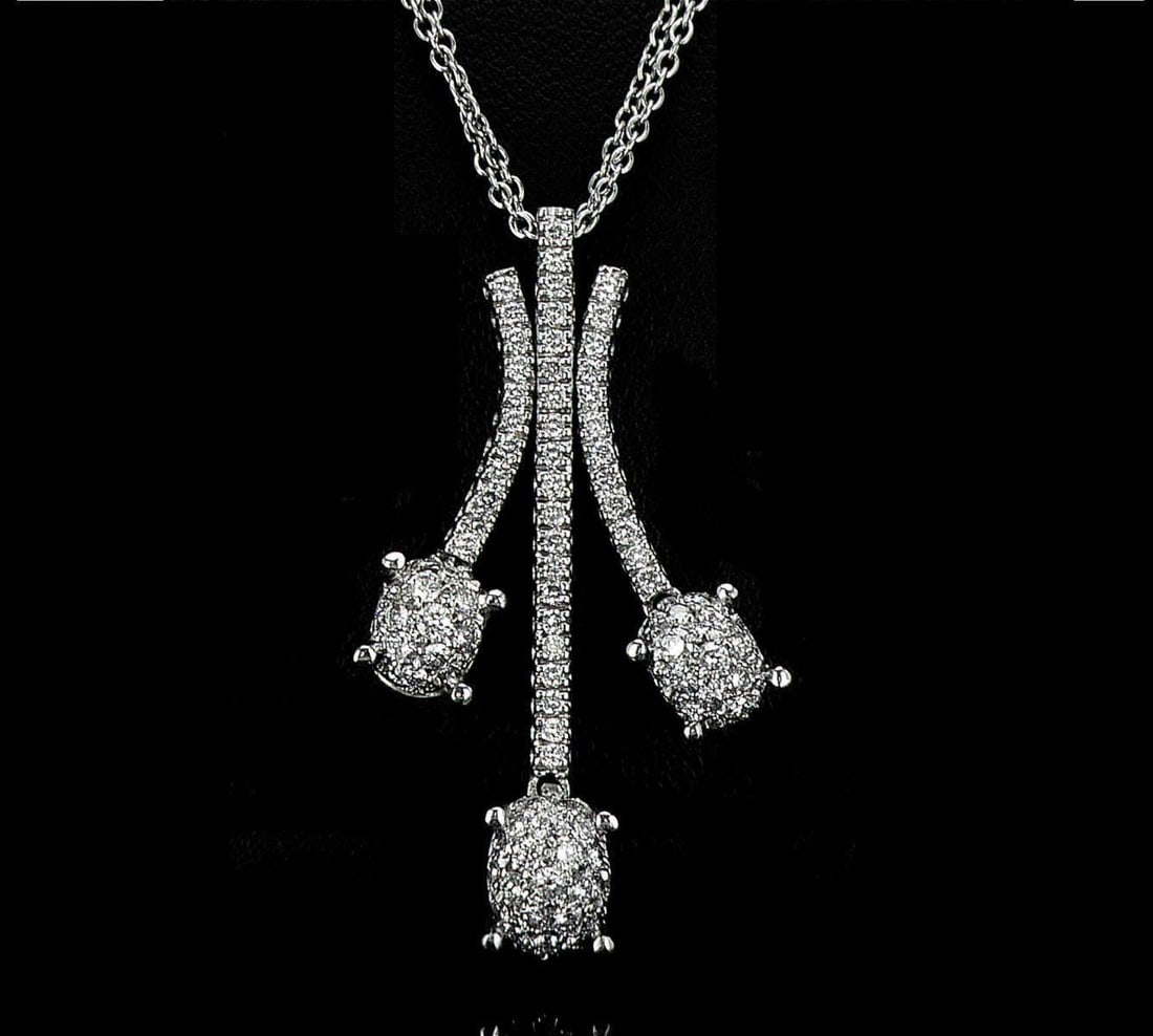 18kt White Gold 1.15ctw Diamond Pendant: One 18k white gold pendant with chain (18k stamped), set with small natural diamonds. Jewelry Weight: 11.47Grs Total Diamonds Weight: 1.15Cts Main Stones Description: Cut and shape: Round Brilliant Ca