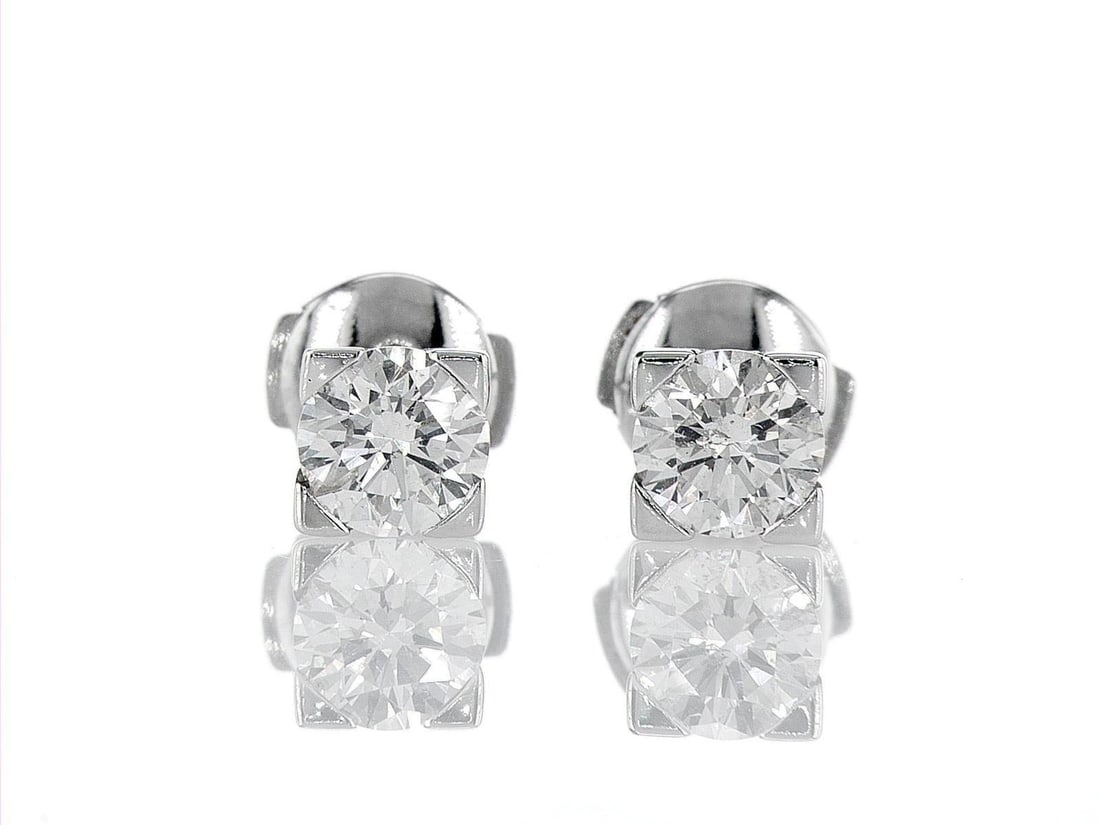 18kt White Gold 1.5ctw Diamond Earrings: One pair of 18k white gold earrings (18k stamped), each set with one natural diamond. Jewelry Weight: 3.57Grs Total Diamonds Weight: 1.5Cts Main Stones Description: Quantity: 2 Cut and shape: Round Br