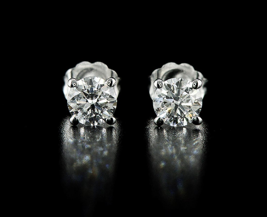 14kt White Gold 1.01ctw Diamond Earrings: One pair of 14k white gold earrings, each set with one natural diamond. Jewelry Weight: 0.88Grs Total Diamonds Weight: 1.01Cts Main Stones Description: Quantity: 2 Cut and shape: Round Brilliant Carat