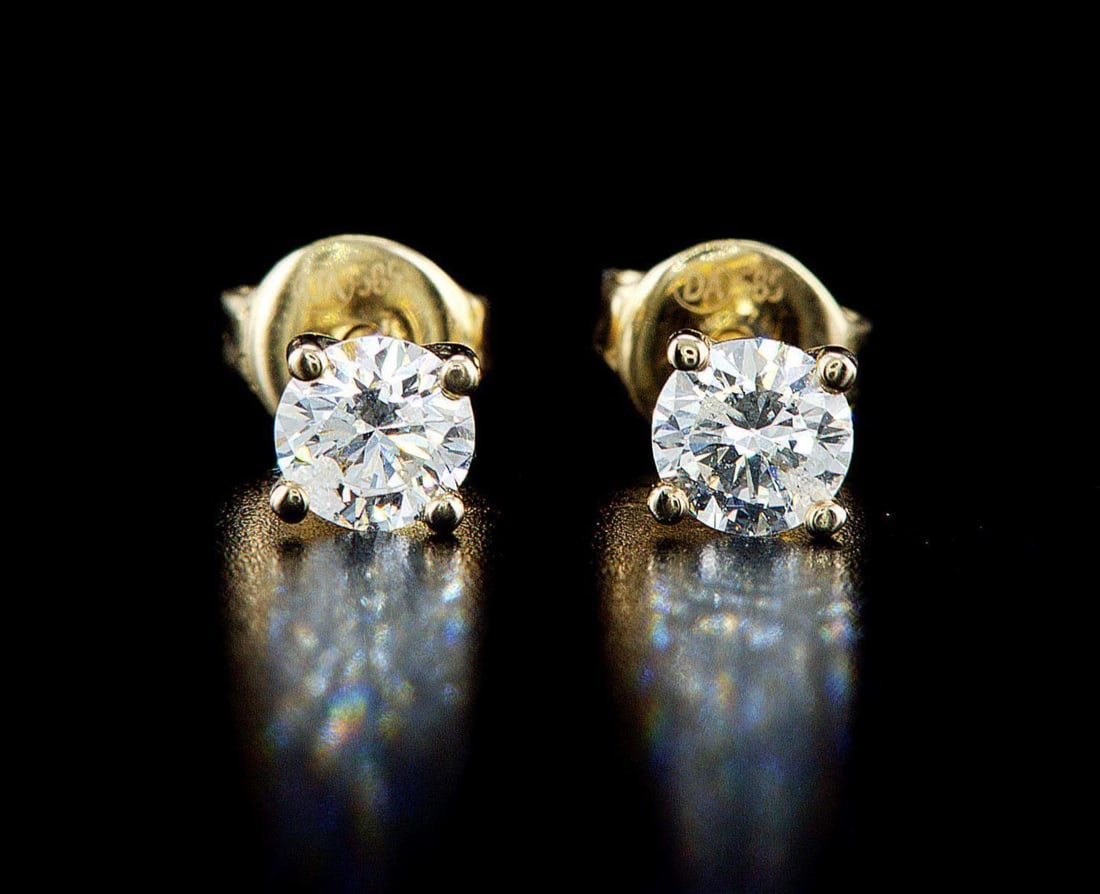 14kt Yellow Gold 0.74ctw Diamond Earrings: One pair of 14k yellow gold earrings (14k stamped), each set with one natural diamond. Jewelry Weight: 1.26Grs Total Diamonds Weight: 0.74Cts Main Stones Description: Quantity: 2 Cut and shape: Round 