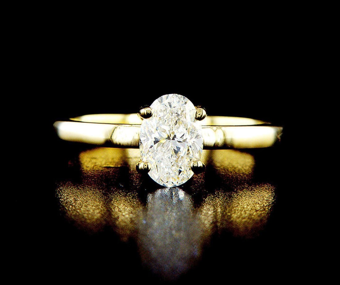 14k yellow gold 1.01ctw Diamond Ring: One 14k yellow gold ring (14k stamped), set with one center natural diamond. Jewelry Weight: 2.65Grs Total Diamonds Weight: 1.01Cts Main Stones Description: Quantity: 1 Cut and shape: Oval Carats Weig