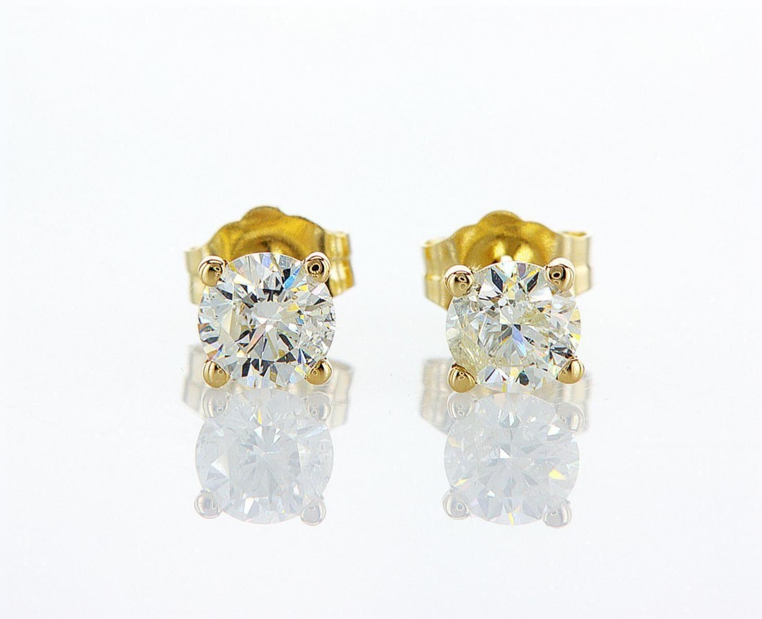 14kt Yellow Gold 0.88ctw Diamond Earrings: One pair of 14k yellow gold earrings (14k stamped), each set with one natural diamond Jewelry Weight: 0.81Grs Total Diamonds Weight: 0.88Cts Main Stones Description: Quantity: 2 Cut and shape: Round B