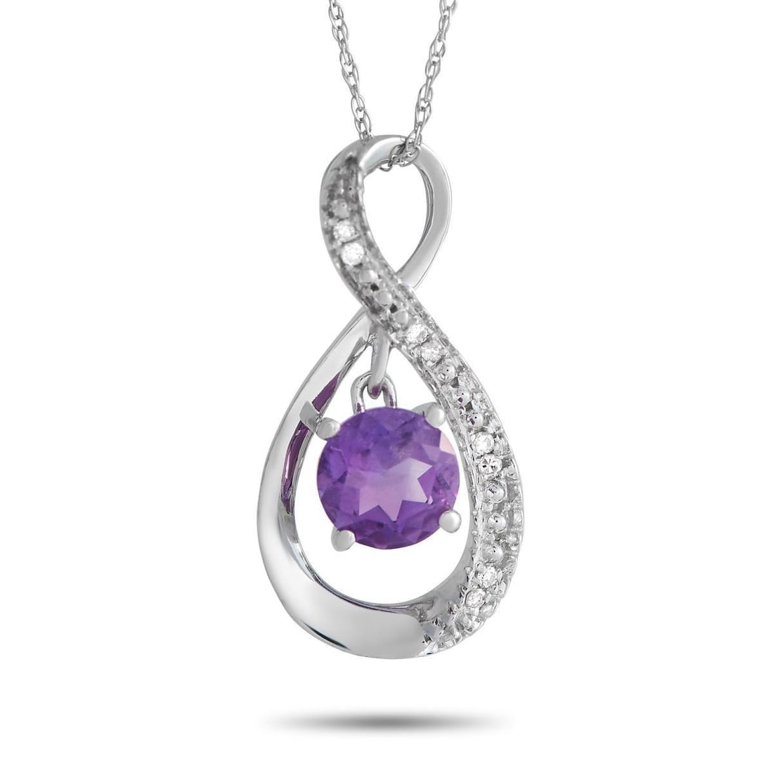 14K WHITE GOLD 0.03CT DIAMOND AND AMETHYST PENDANT NECKLACE: Here is an infinitely stylish necklace making a statement through the lovely shine of diamonds and the lively sparkle of a round amethyst. It features an 18 chain with a spring ring clasp, holding a 0